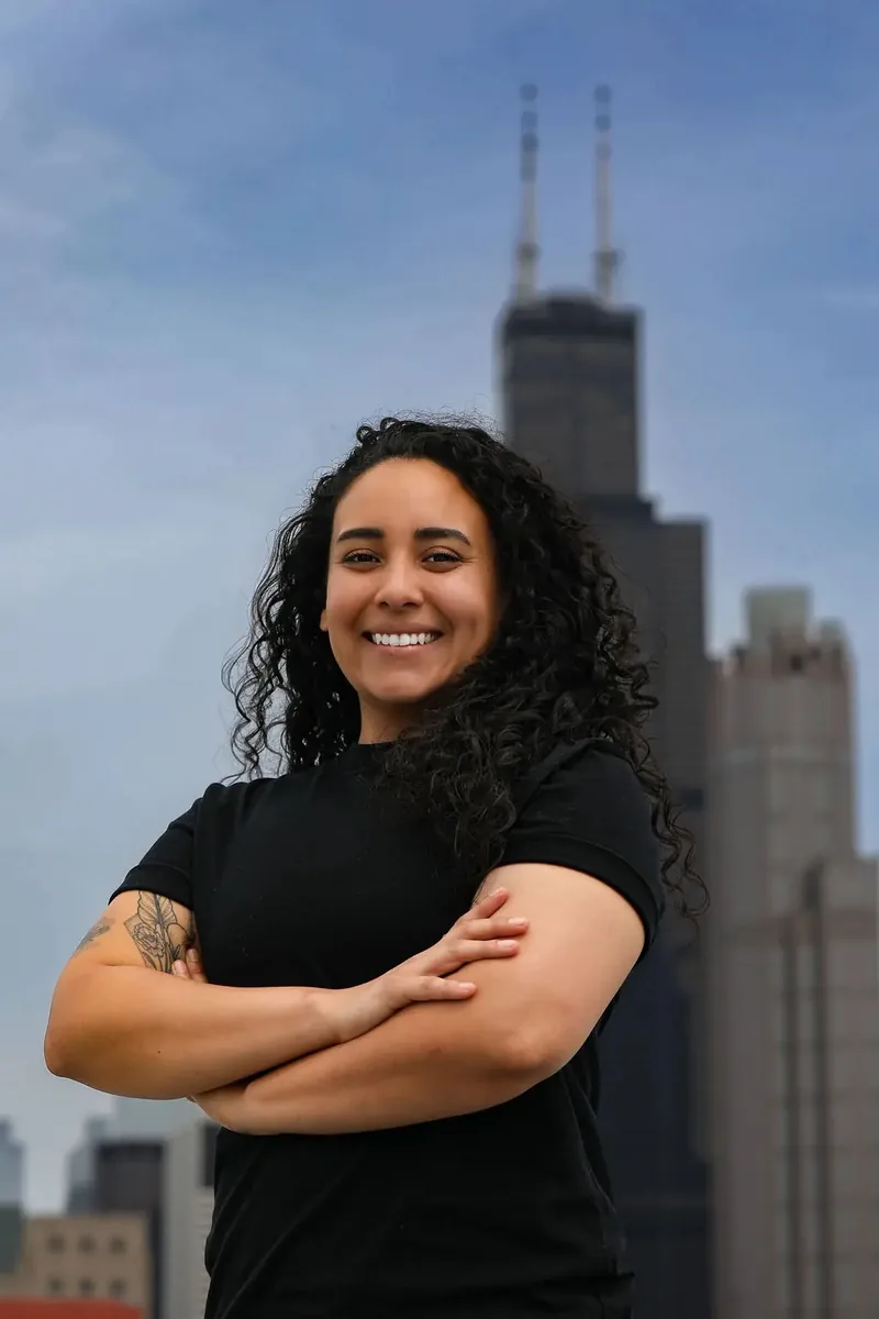 Karen Rodriguez, licensed Illinois real estate broker and managing partner at Dello Investments, photographed against the Chicago skyline.