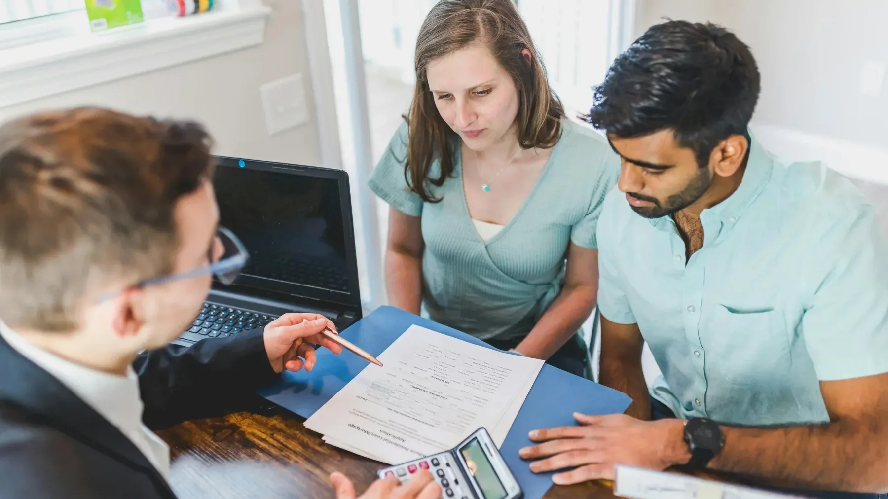 Couple going over loan paperwork with an advisor
