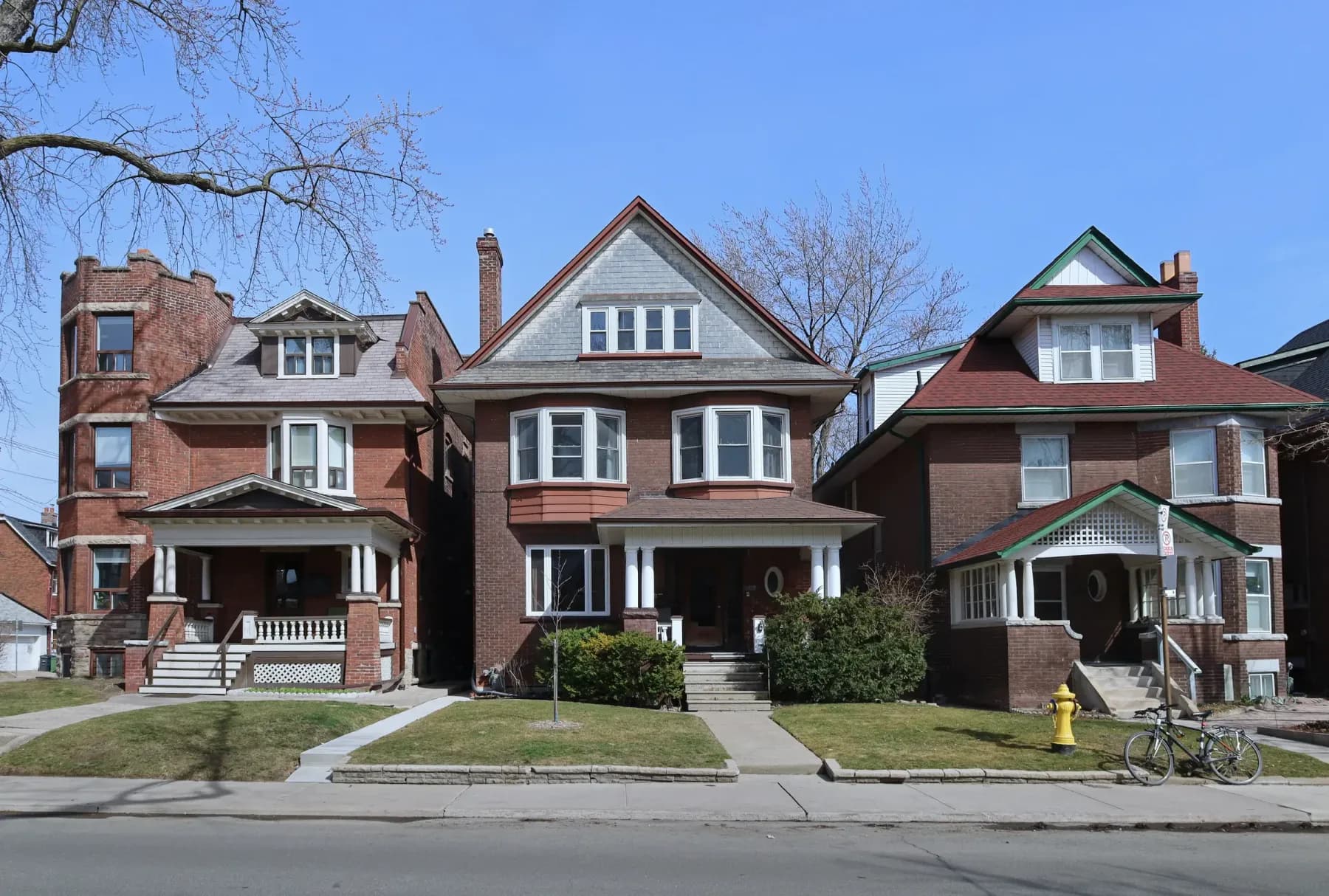 Three brick and frame houses on a Chicago residential street